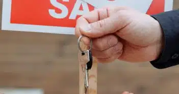 Person Handing Out Keys to Another Person