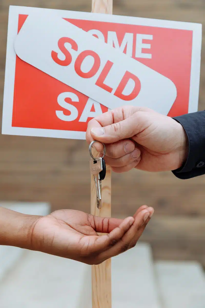 Person Handing Out Keys to Another Person