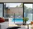 brown sofa near glass window